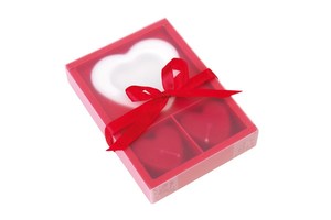 Candle set "2 Hearts" consists of 2 red perfumed candles and a heart shaped holder